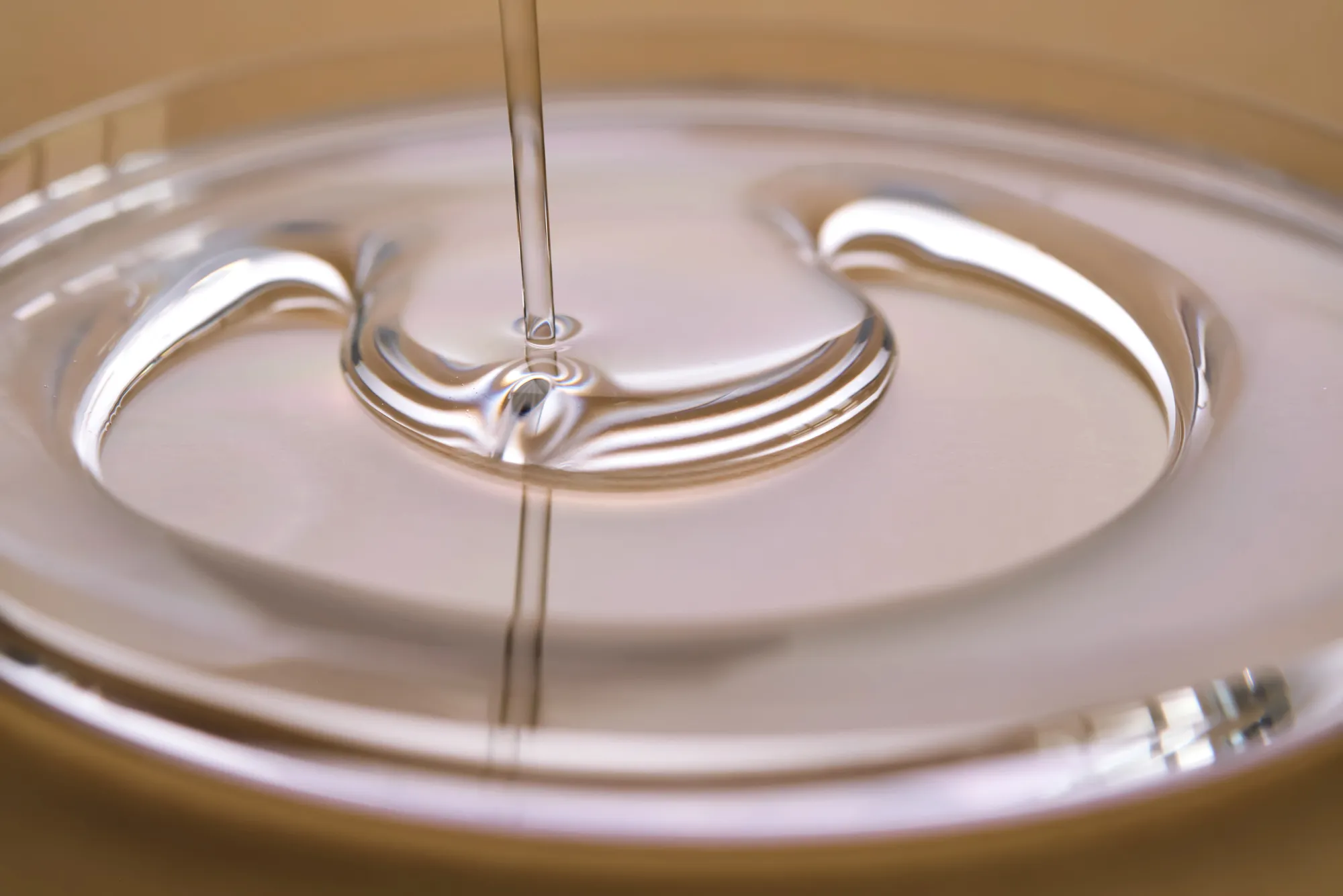 Merxally a-juicy-drop-of-gel-on-a-beige-background-image